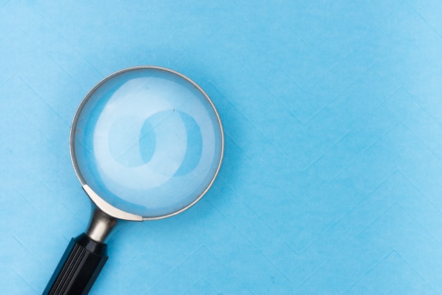 Magnifying glass against a blue background