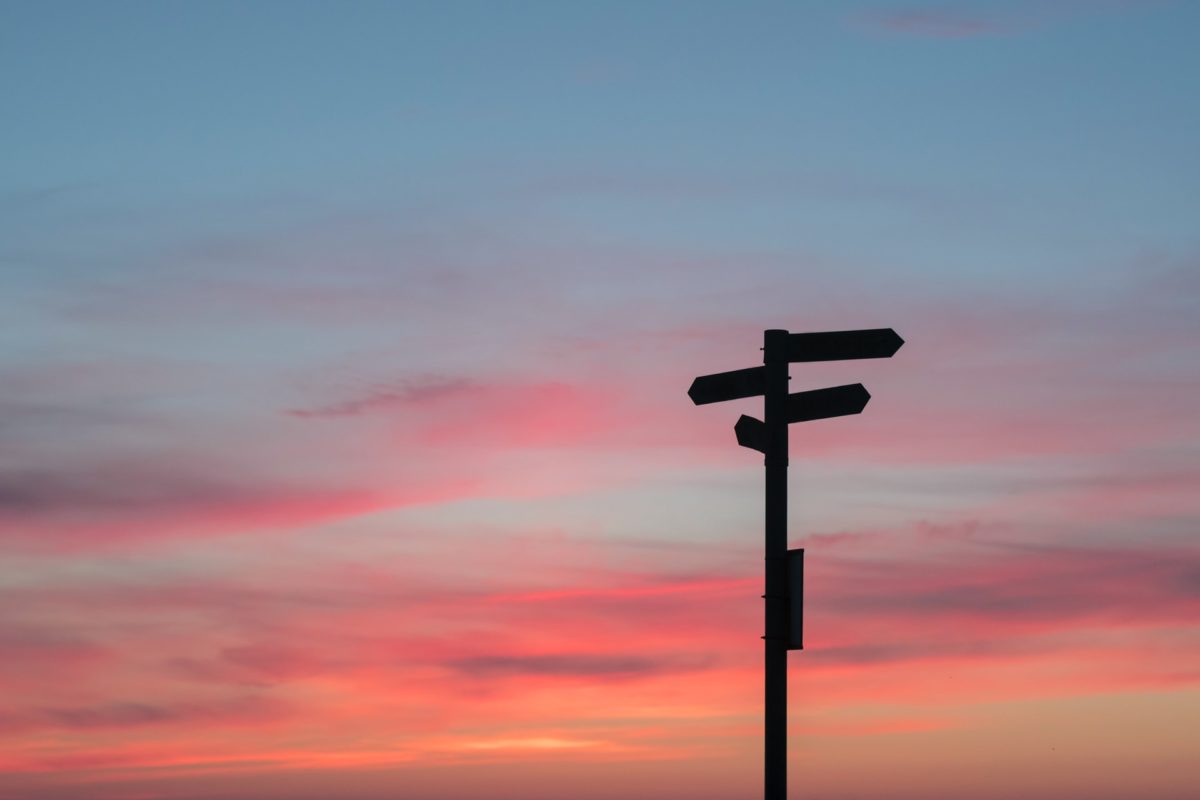 Signpost against a sunset sky