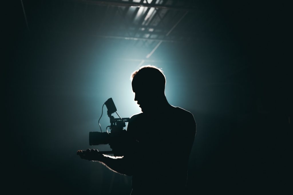 man filming a scene