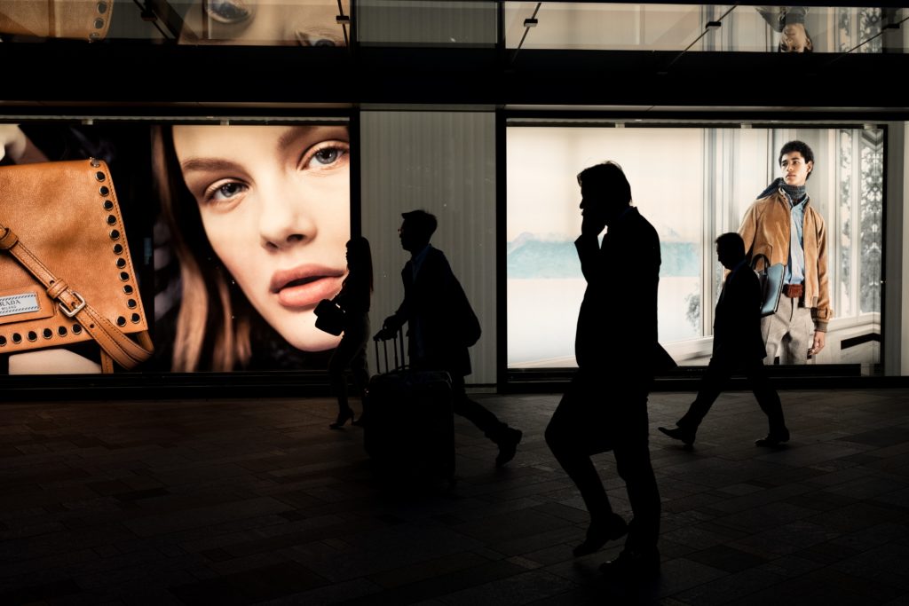 people walking in front of adverts