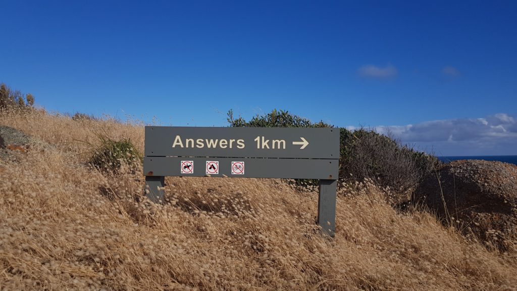 Road sign indicating Answers in one kilometre