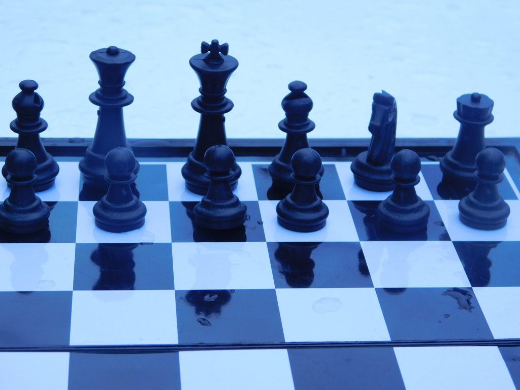 Black chess pieces lined up on a board