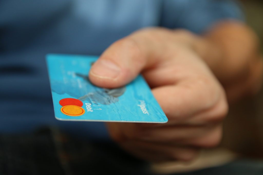 Man handing over a debit card