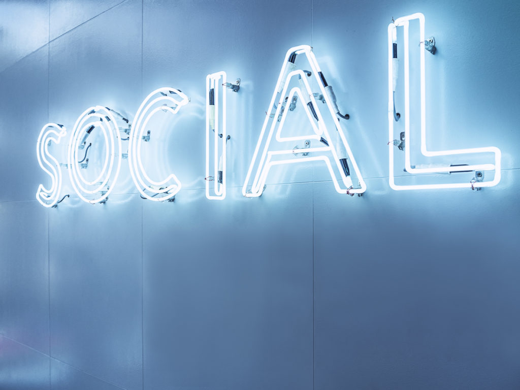 Social Media Type font Neon sign light Blue tone Signage on wall in Perspective