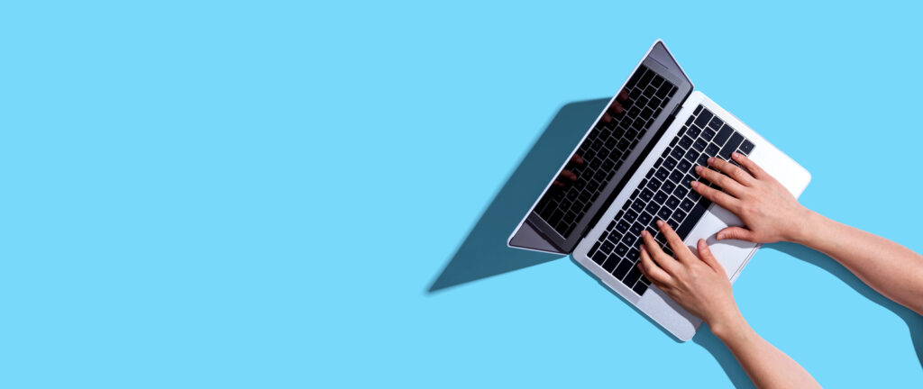 Person using a laptop computer from above