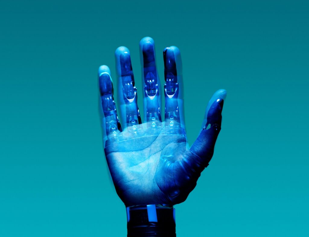A robotic blue hand reaching upwards