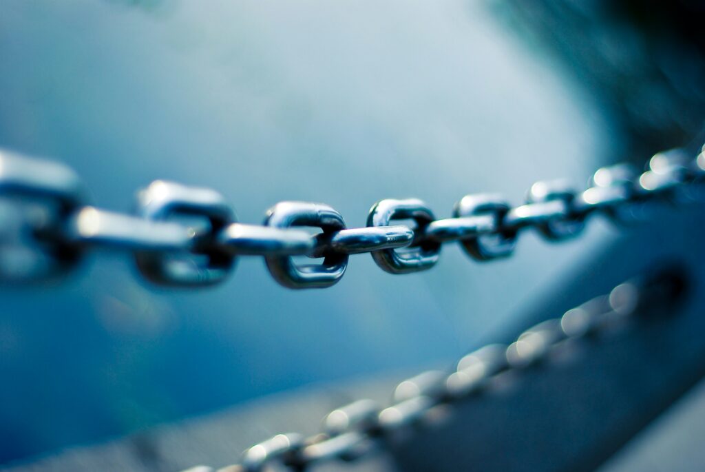 Metal chains against a blue background