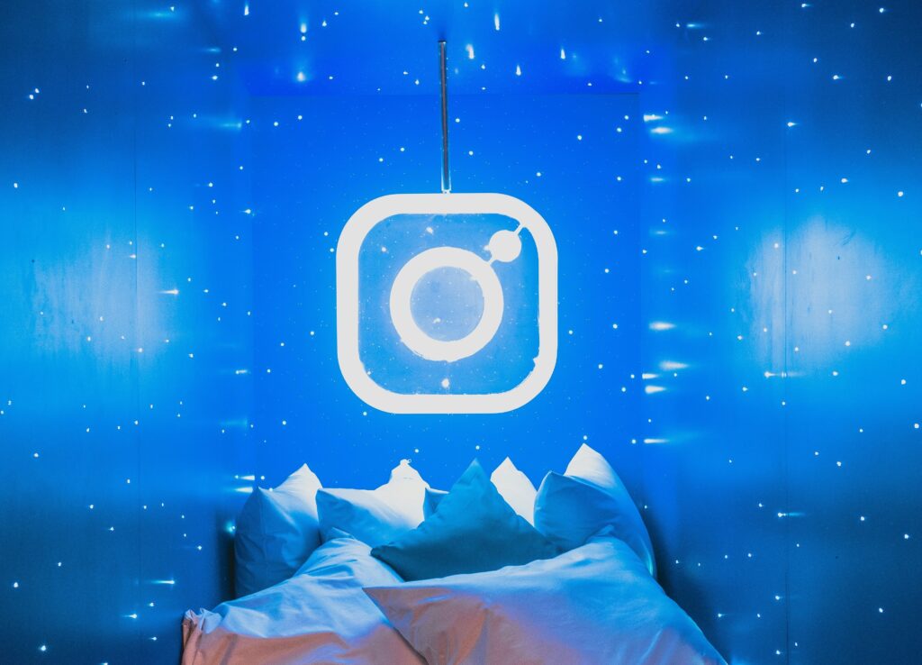 Neon Instagram logo with cushions below